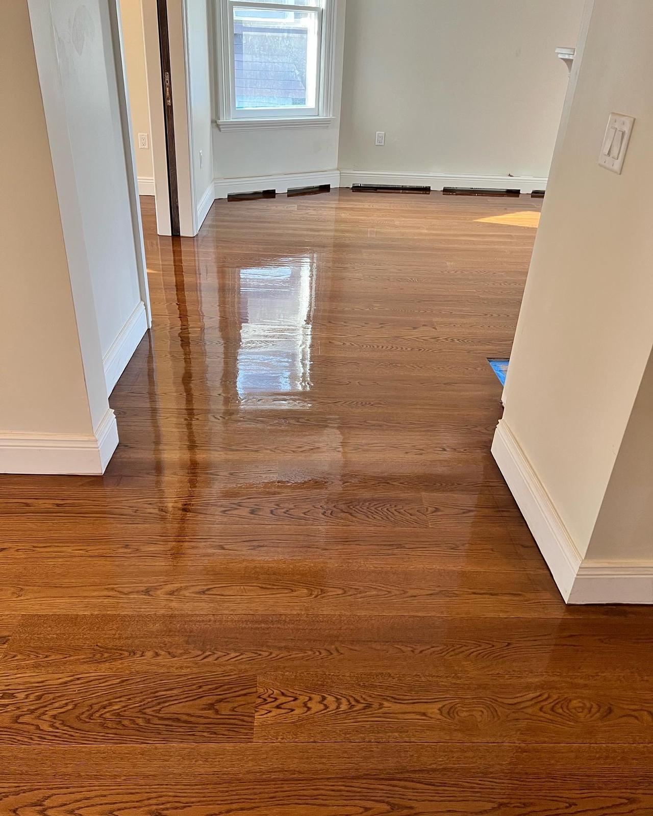 Glossy refinished hardwood floor in a hallway